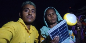 Anwar makes a solar light sale in an Indian slum