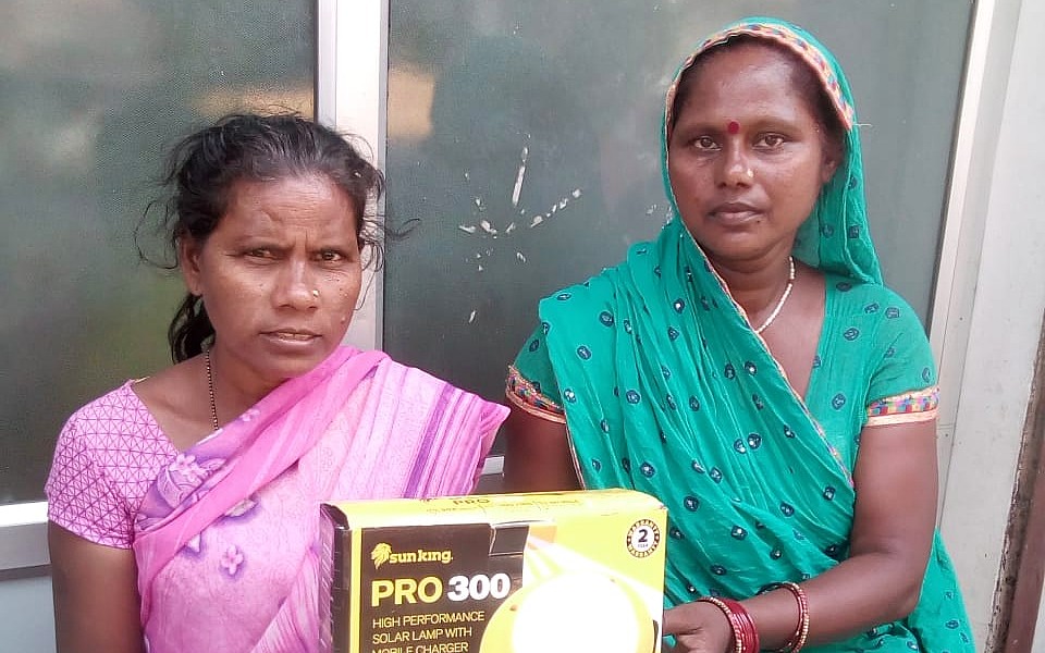 Women living in poverty with solar light in India
